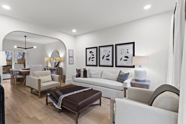 living room with a notable chandelier and light wood-type flooring