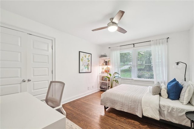 bedroom featuring baseboards, ceiling fan, and wood finished floors