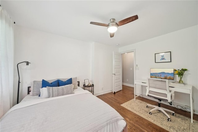 bedroom featuring baseboards, a ceiling fan, and wood finished floors
