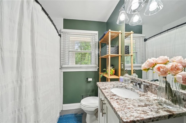 bathroom with visible vents, vanity, baseboards, toilet, and an inviting chandelier