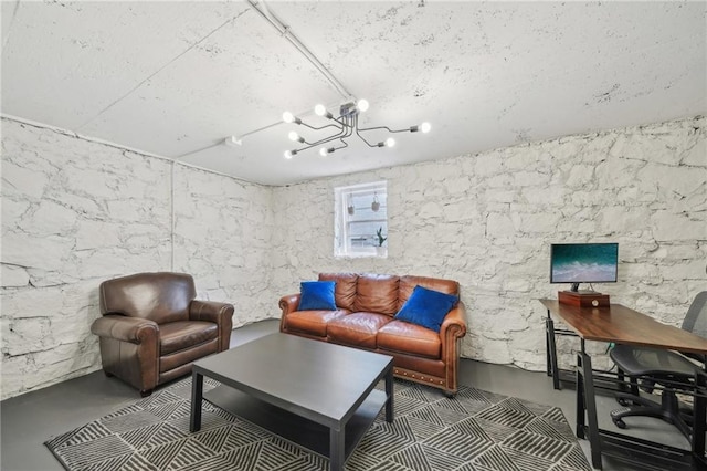living room featuring concrete flooring and a chandelier