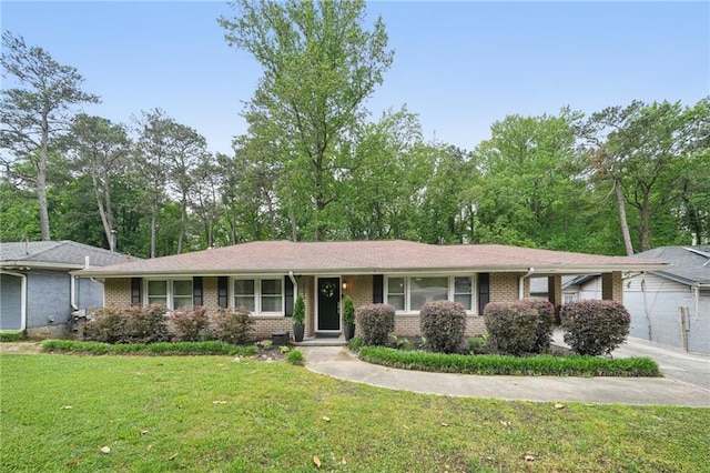 single story home with brick siding and a front lawn