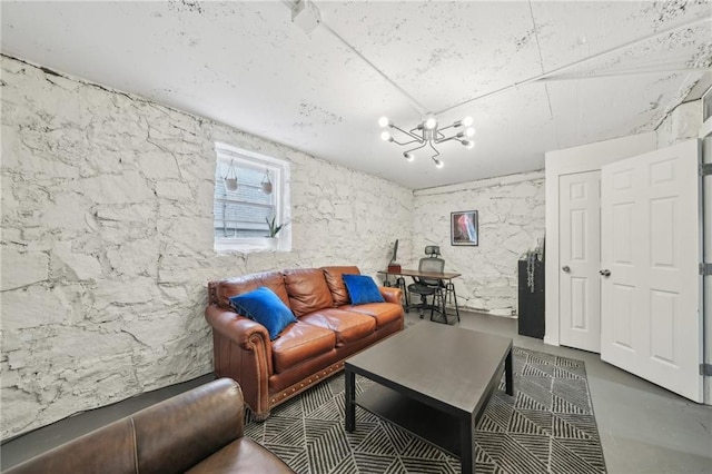 living area featuring a chandelier and concrete floors