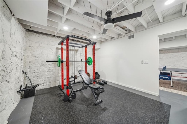exercise room with visible vents and ceiling fan
