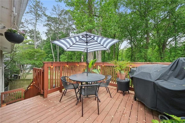 wooden deck featuring outdoor dining area