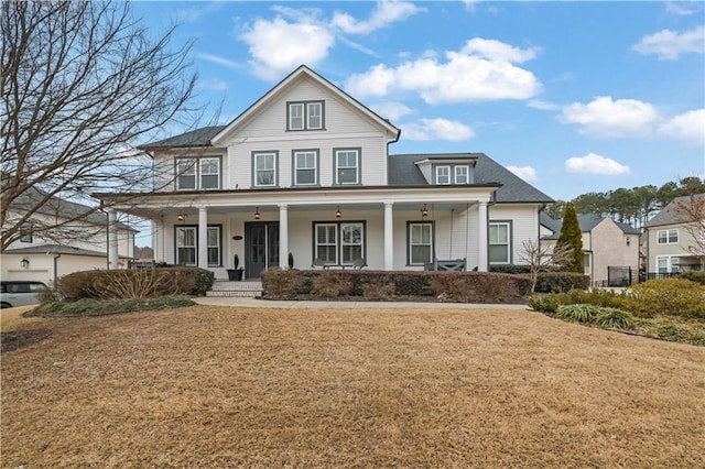 view of front of home with a porch and a front yard