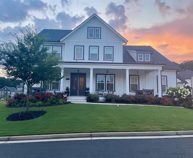 view of front of house featuring a yard and covered porch