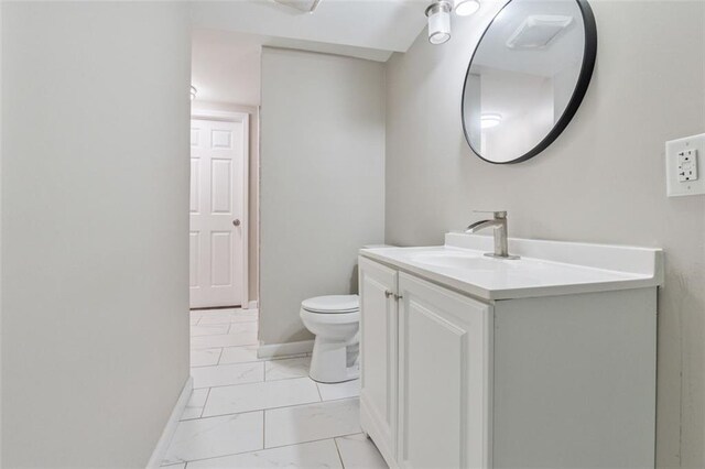 2172 SE Wakita Dr SE, Marietta, GA 30060 - bathroom featuring vanity, marble look tile flooring, toilet, and baseboards