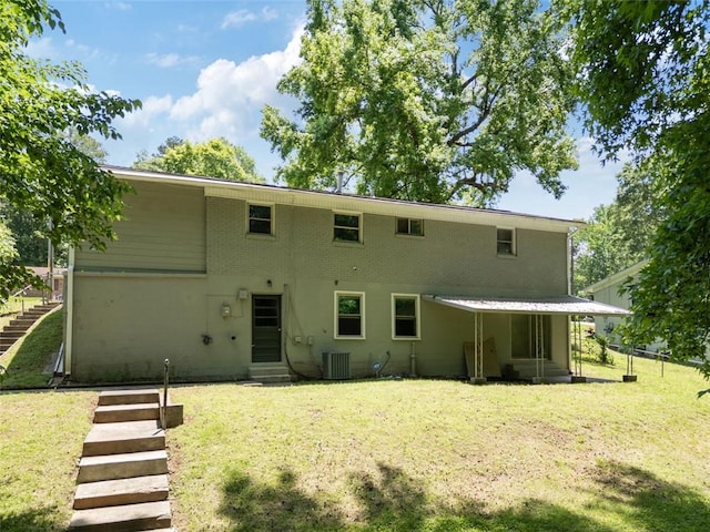 2172 SE Wakita Dr SE, Marietta, GA 30060 - back of house with a yard, brick siding, and central AC