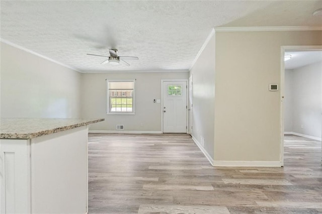 2172 SE Wakita Dr SE, Marietta, GA 30060 - entrance foyer featuring a ceiling fan, light wood-type flooring, a textured ceiling, crown molding, and baseboards