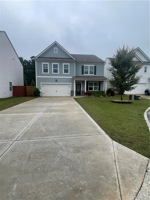 37 Creekbed Ct, Dawsonville, GA 30534 - view of front of house with an attached garage, driveway, and board and batten siding