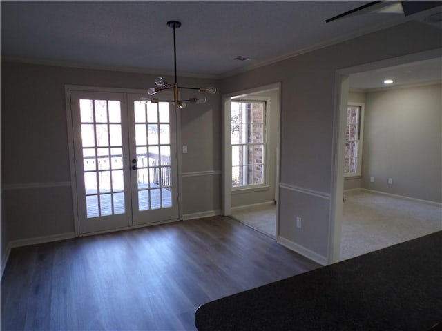 interior space featuring wood finished floors, visible vents, baseboards, french doors, and ornamental molding