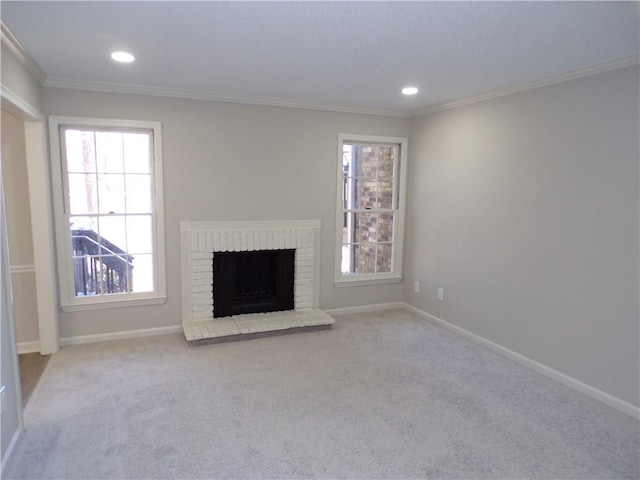 unfurnished living room featuring baseboards, a brick fireplace, carpet flooring, and crown molding