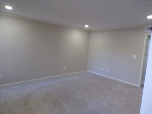 spare room featuring carpet floors, recessed lighting, visible vents, and baseboards