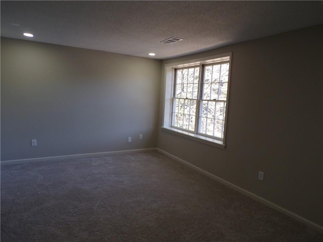 carpeted empty room featuring a textured ceiling, recessed lighting, visible vents, and baseboards