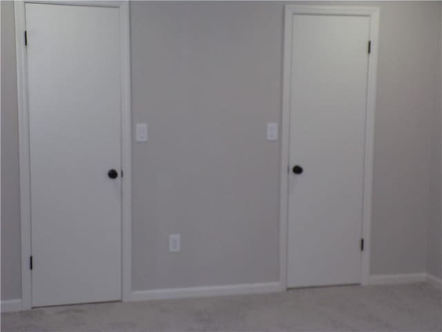 unfurnished bedroom with baseboards and a closet