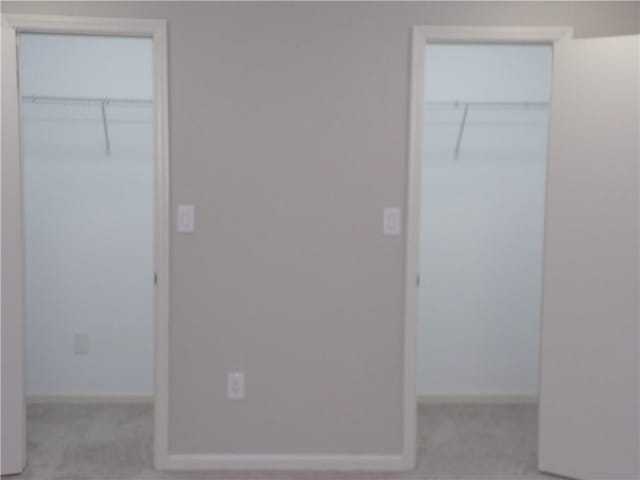 unfurnished bedroom with light carpet and baseboards