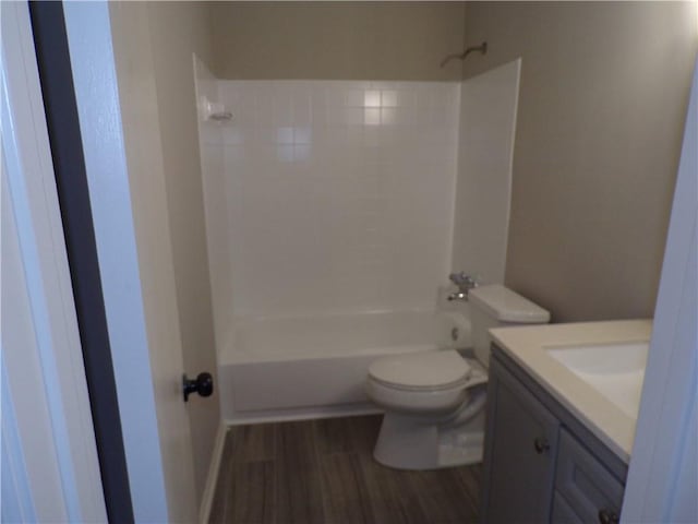 bathroom with vanity, tub / shower combination, wood finished floors, and toilet