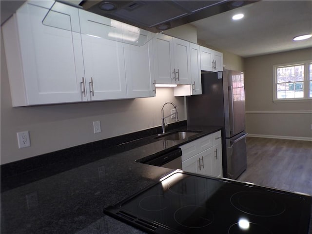 kitchen featuring black electric range oven, a sink, dishwasher, and white cabinetry