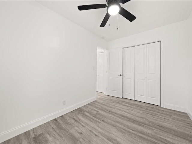 unfurnished bedroom featuring a closet, ceiling fan, and light hardwood / wood-style flooring