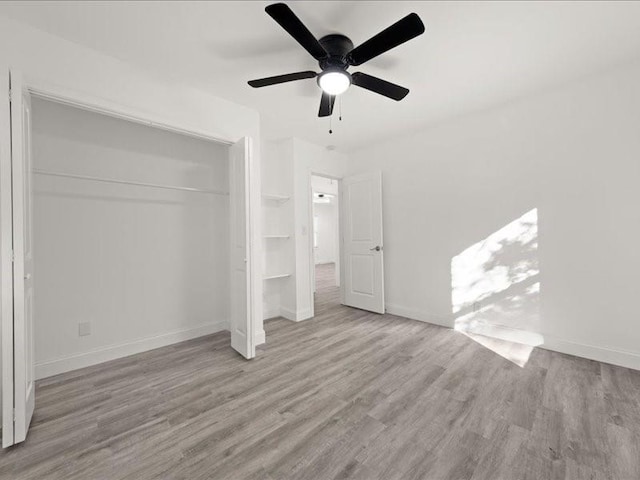 unfurnished bedroom with light hardwood / wood-style flooring, ceiling fan, and a closet