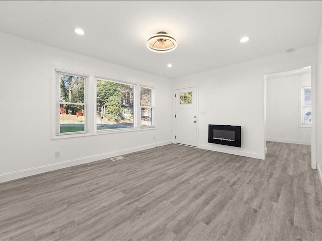 unfurnished living room with light hardwood / wood-style flooring