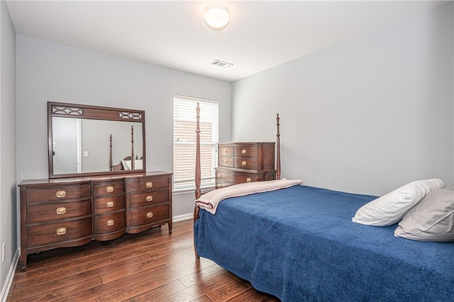 bedroom featuring visible vents, wood finished floors, and baseboards