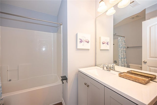 full bathroom featuring visible vents, vanity, toilet, and shower / tub combo