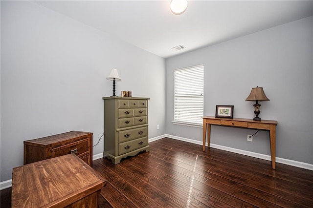 interior space with visible vents, baseboards, and wood finished floors