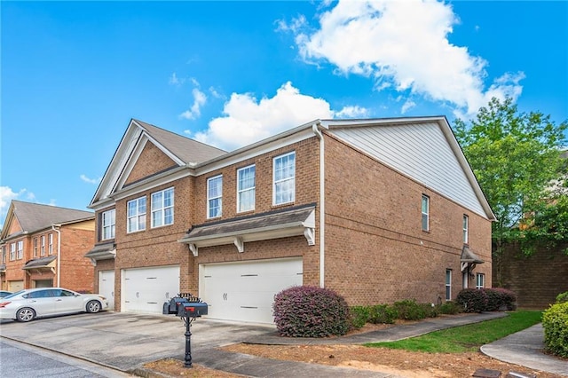 view of home's exterior with concrete driveway, an attached garage, and brick siding