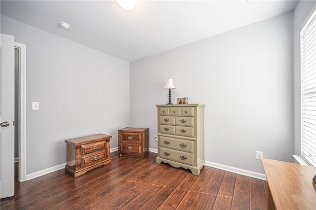 bedroom with baseboards and wood finished floors