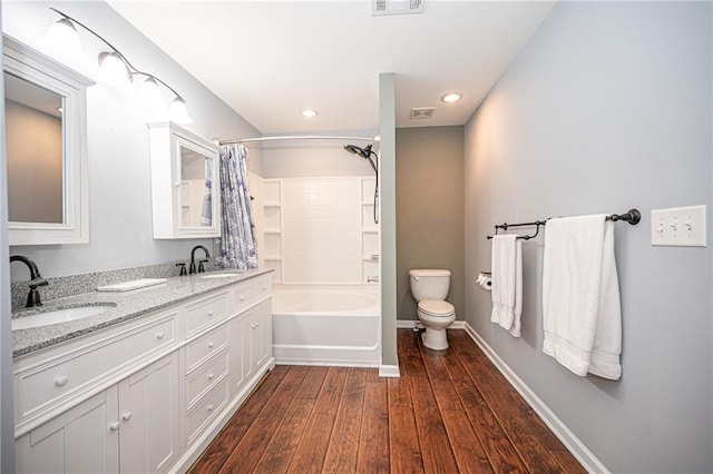 full bathroom featuring a sink, baseboards, toilet, and wood finished floors