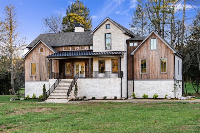 modern farmhouse style home with a front lawn and covered porch