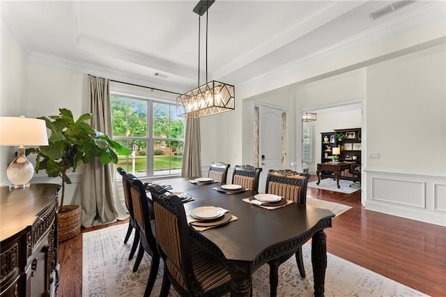 4896 Locklear Way, Marietta, GA 30066 - dining space with a chandelier, wood finished floors, a raised ceiling, a wainscoted wall, and crown molding