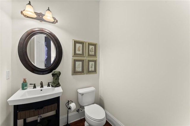 4896 Locklear Way, Marietta, GA 30066 - bathroom with toilet, a sink, baseboards, and wood finished floors
