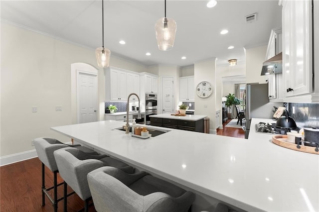 4896 Locklear Way, Marietta, GA 30066 - kitchen with a sink, a center island, white cabinets, a kitchen bar, and recessed lighting
