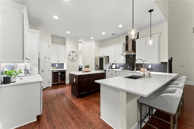 4896 Locklear Way, Marietta, GA 30066 - kitchen featuring wall chimney range hood, beverage cooler, tasteful backsplash, ornamental molding, and dark wood-type flooring