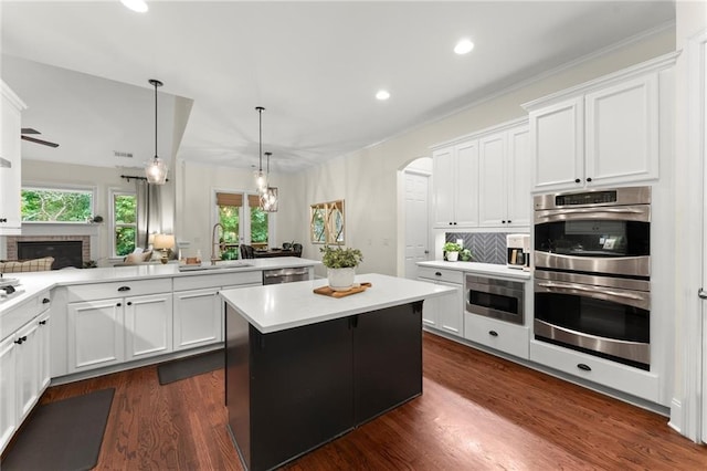 4896 Locklear Way, Marietta, GA 30066 - kitchen featuring stainless steel appliances, a sink, arched walkways, a kitchen island, and recessed lighting