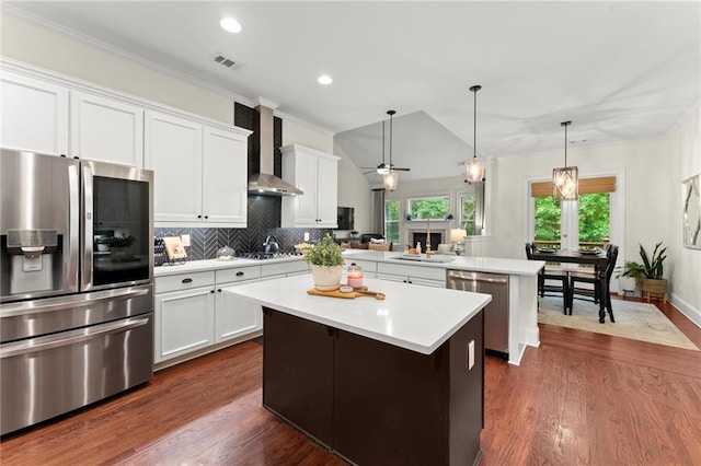 4896 Locklear Way, Marietta, GA 30066 - kitchen with appliances with stainless steel finishes, wall chimney exhaust hood, a peninsula, a kitchen island, and light countertops