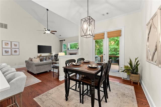 4896 Locklear Way, Marietta, GA 30066 - dining area featuring a ceiling fan, dark wood finished floors, vaulted ceiling, baseboards, and crown molding
