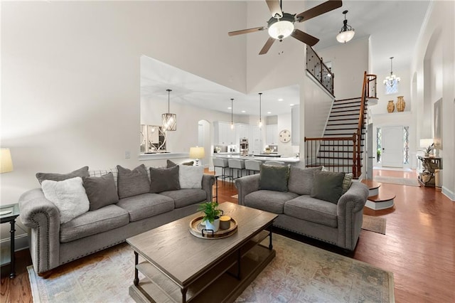 4896 Locklear Way, Marietta, GA 30066 - living area featuring a high ceiling, a ceiling fan, light wood-style floors, a chandelier, and stairway