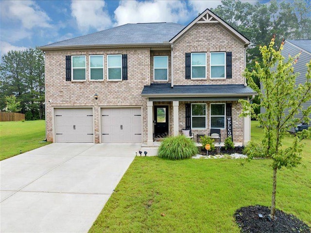 craftsman house with an attached garage, a porch, a front yard, concrete driveway, and brick siding