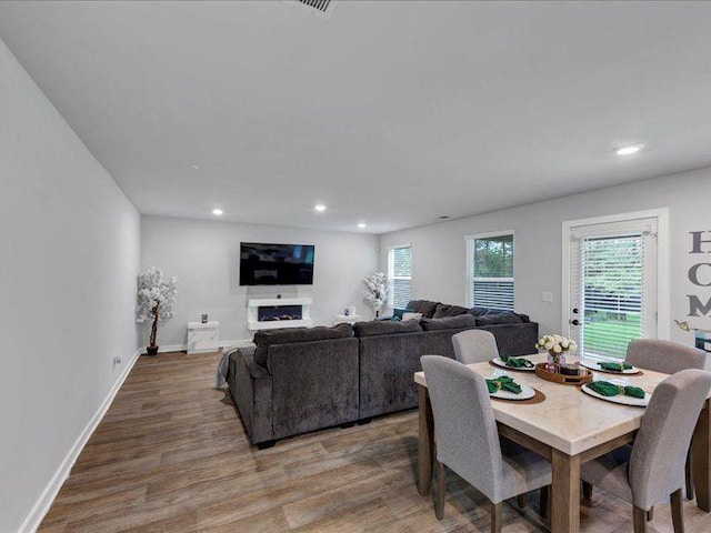 dining space with wood finished floors, recessed lighting, and baseboards