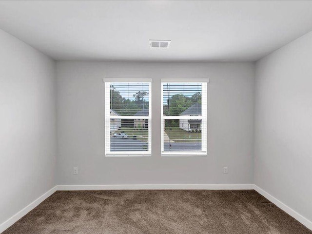 spare room with carpet floors and baseboards