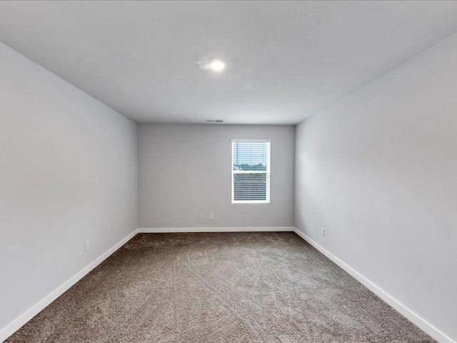 carpeted spare room with baseboards