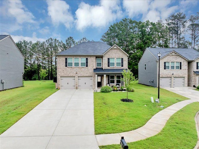 craftsman-style house with a garage, driveway, brick siding, and a front yard