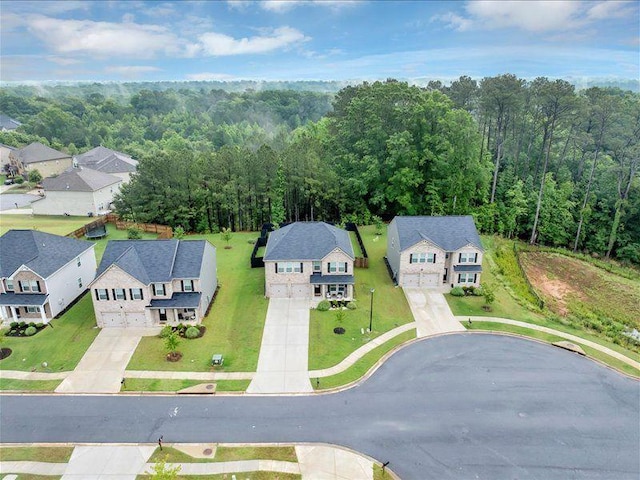 aerial view of residential area featuring a forest