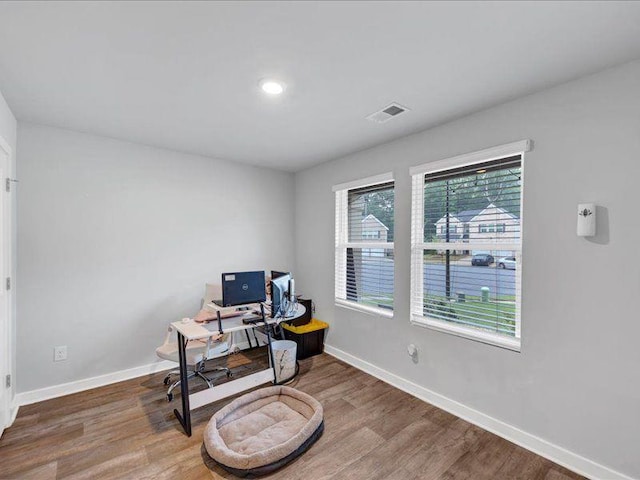 home office featuring baseboards and wood finished floors