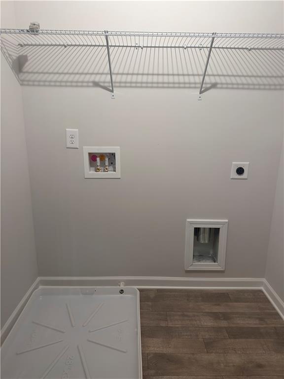 washroom with wood finished floors, laundry area, hookup for an electric dryer, baseboards, and hookup for a washing machine