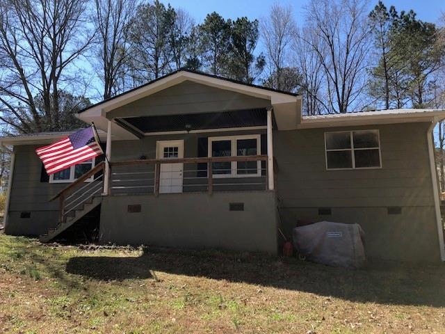 view of front facade featuring crawl space and stairway